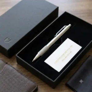 An executive stainless steel pen presented inside a luxury matte black gift presentation box.